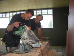 Carpenter Tony Failla (left) and Bill Anton cut trim as the Spartans eatery takes shape upstairs at the Pavilion. Anton