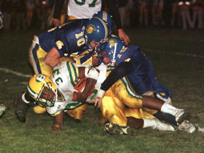 Scott Burkland (top of pile) and Spartan teammates gang up on Blanchet running back Marcus Partman during Friday evening play. Strong defense early and late keyed the 35-14 victory.