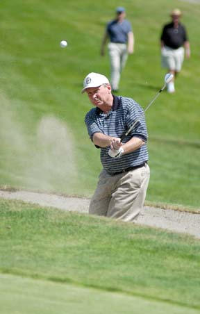 Nick West chips out of a bunker onto the fifth green at Wing Point.