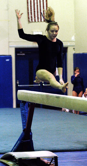 Kristen Hertz launches off the spring board as she starts her routine on beam at Friday’s home meet against Ingraham and Nathan Hale. The Spartans came away with the win and several competition firsts for the team.