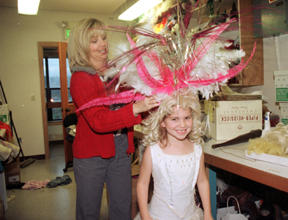 Shannon Sheehan adjusts daughter Lauren’s elaborate feather head dress. The Blakely Elementary School first-grader makes her stage debut Dec. 4 in the BPA theater school production of “The Nutcracker.”