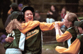 Sarah Wettleson is mobbed by teammates after scoring the winning run in the Storm’s Majors softball championship-game victory over the Diamonds. Wettleson scored on an RBI single by Jessica Molskness.