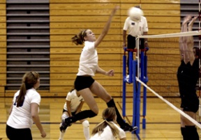 Kelcey Dunaway spikes the ball during the third game against the Holy Names Cougars on Monday.