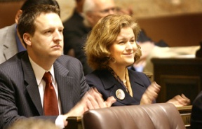 Rep. Dave Upthegrove (D-Des Moines) and Rep. Christine Rolfes (D-Bainbridge Island) applaud a speech in the House Chamber on Monday.