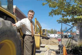 American Marine Bank president Rex Townsend stands in front of the park between AMB and WAMU