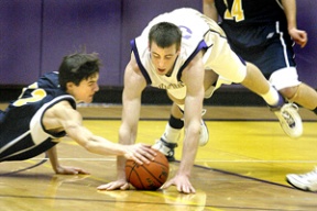 Nick Fling (left) scrambles for the loose ball Friday night against North Kitsap.