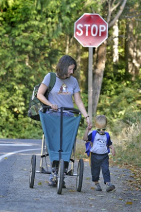 Laura Gano walks home with her 2-year-old son Rowan after dropping her school-age kids at Blakely Elementary on Wednesday.