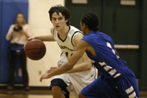 Nick Fling brings the ball upcourt against the Rams in boys play the following evening