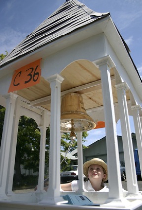 Eagle Harbor Congregational Church member Mary Macpherson waits to tow the bell and miniature steeple through the Grand Old Fourth parade.