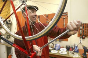 Classic Cycle customer Paul Johnson works on his bike with help from the shop’s bike mechanic/manager. He was modifying his bike to perform better in rainy weather.