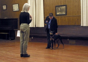 Dog trainer Judith Bell looks on as Jan Michael asks her dog