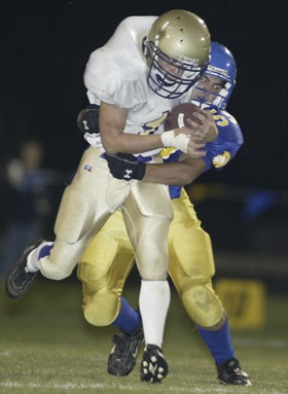 Spartan defensive lineman Nate Draper makes an open field tackle on Sequim running back Adrien Gault.