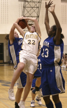 Spartan guard Caitlyn Salo is brought down hard while driving to the basket late in the Spartan girls’ 61-40 win over Ingraham Tuesday.