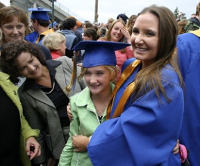 Natalie Moore lets her younger cousin Grace Carter try on her mortar board for size