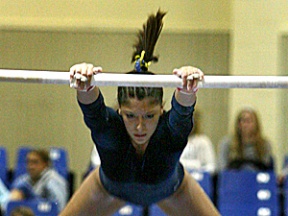 Marie Welsh performs her bar routine Friday night at the Tacoma Dome Exhibition Hall. The junior came home with three titles in the vault