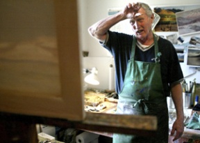 Hank Hays looks over a landscape oil painting he’s working on for a Pegasus Coffee House show. A former forester