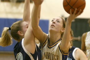 Julia Weese (right) fights for the layin against Meadowdale Thursday night at Paski Gymnasium. She finished with four rebounds.