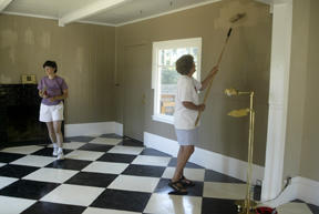 Terry Cowen (left) and Phyllis Marx touch up the main room in the new Reform Jewish center on Winslow Way.