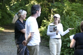 Rebecca Robbins (in cap) discusses the city’s plans for Kallgren Road with neighbor Susan Scheirman and Robbins’ husband