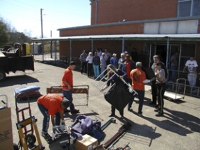 Local prisoners unload furniture and tools donated by Bainbridge Islanders and trucked to Abbeville