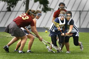 Tarie Cauoette (far right) helps her teammates fight for a ground ball against Lakeside Wednesday night. Bainbridge won 12-10.