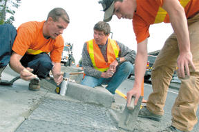 Lorenz Eber (center) inspects work on new pedestrian islands this week.