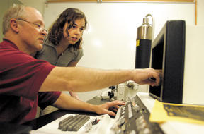 Biology teacher Bruce Claiborne and BHS junior Nissa Kahle examine a speck of cloud sponge with the school’s newly acquired scanning electron microscope. The district secured the instrument for $9