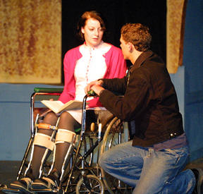 Brandon Belieu (right) kneels to converse with Nicole Gregory