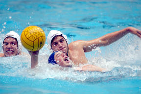 Bainbridge’s Jake Santelli (with ball) is pressured by a pair of Kentridge defenders during Team Ray’s 10-9 victory over the Chargers Sunday at King County Aquatic Center. Santelli regained his composure and scored on the play