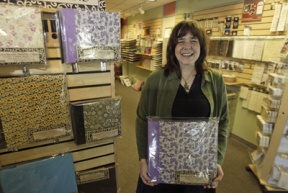 Co-owner Alyse McConnell shows off the wares of Scrapbooks Etc.