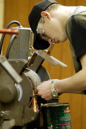 BHS student Kyle Mann works at a grinder at the West Sound Technical Skills Center in Bremerton. The center boasts a fully equipped machine shop.