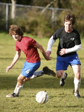 Defender Leandre Fischer (left) and forward Tyler Church battle for possession during practice this week. The Spartans open non-league play Monday at North Kitsap. Game time is at 6:45 p.m.