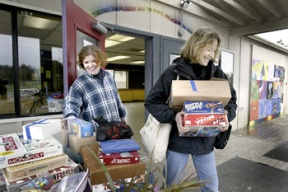 Teen Center director Shannon Buxton (left) and Cultural Arts Supervisor Sue Hylen lug the last items from the Teen Center to its temporary home at the Bainbridge Aquatics Center.