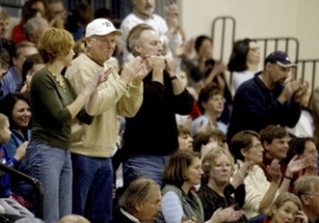 Tom Kelly (center) in his natural environment: courtside for Spartan basketball.