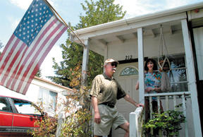 Gregg Weist and Lisa Manning spend a little time outdoors at the Islander Mobile Home Park Friday afternoon. They cite cost and convenience as two major factors in choosing to live in the mobile home community northeast of City Hall.