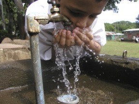 Balgue elementary school student Josue Monge drinks deeply from a clean water system built with Bainbridge Island’s help.