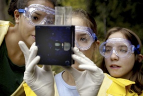 Woodward Middle School seventh-graders Naomi Gaunavinaka and Kristin and Becky Gordon check the pH of Manzanita Creek's waters.