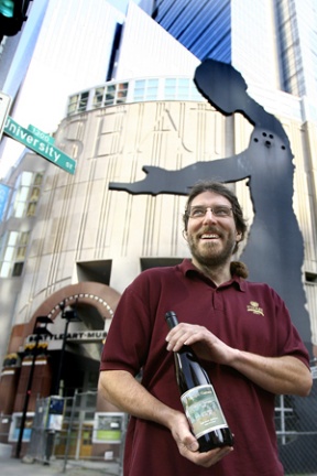 Island  winemaker Mike Lempriere shows off a bottle of his Perennial Vintner wine while delivering it to his first customer