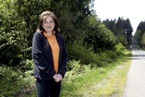 Wini Jones stands at the intersection of New Brooklyn and Sportsman Club roads