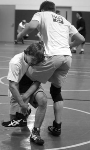 Zach Smith goes for the leg of Ian Brooks during wrestling practice recently.