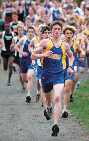 Bainbridge High senior Nolan Amy leads the pack at the start of Wednesday’s cross country meet at Lower Woodland Park in Seattle. Amy placed first in the race