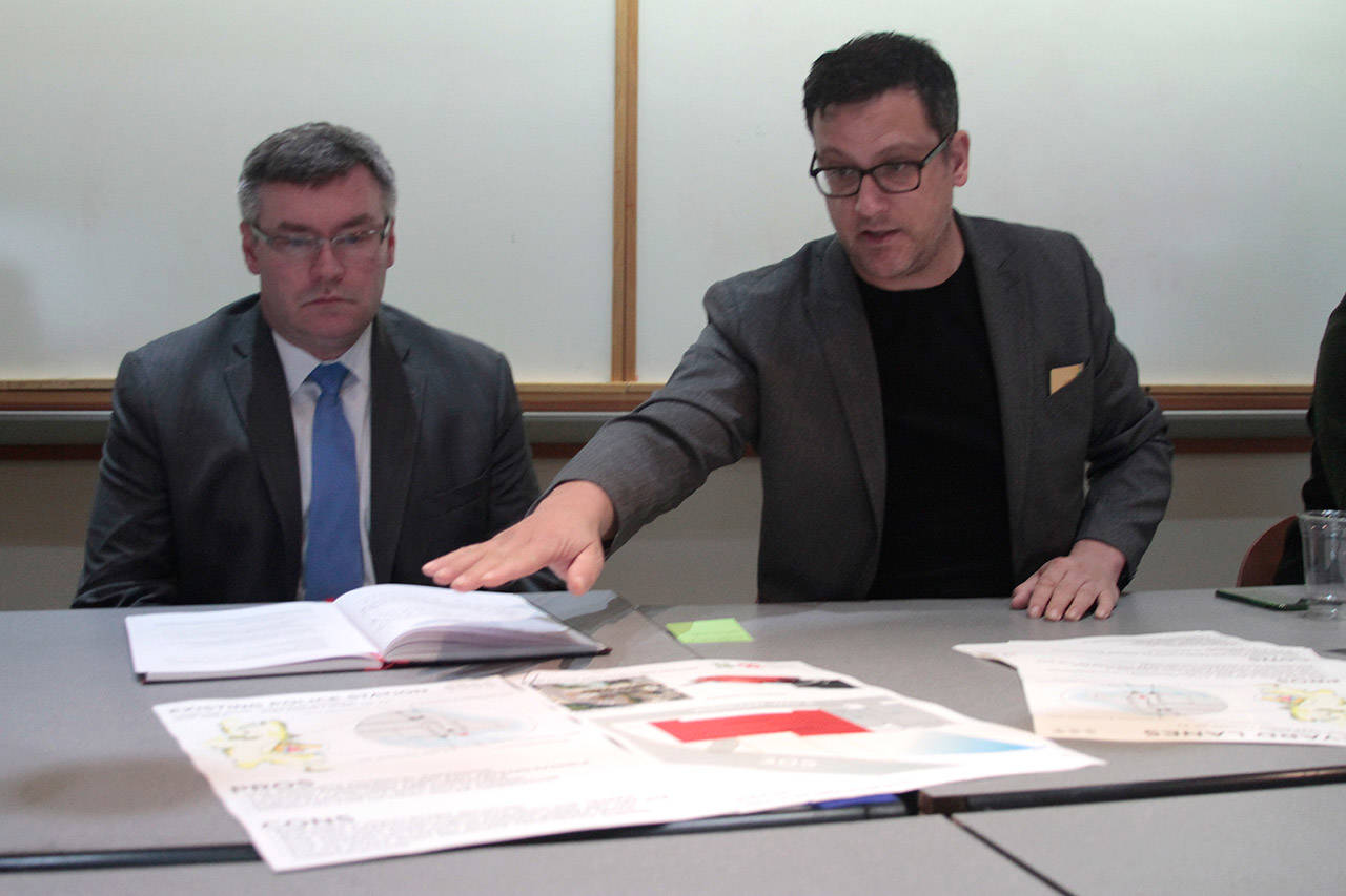 Luciano Marano | Bainbridge Island Review — Bainbridge Island City Manager Doug Schulze and Matthew Coates, president of Coates Design, unveil comparison charts of the three sites found to be the most preferable to serve as the location of the new police station.