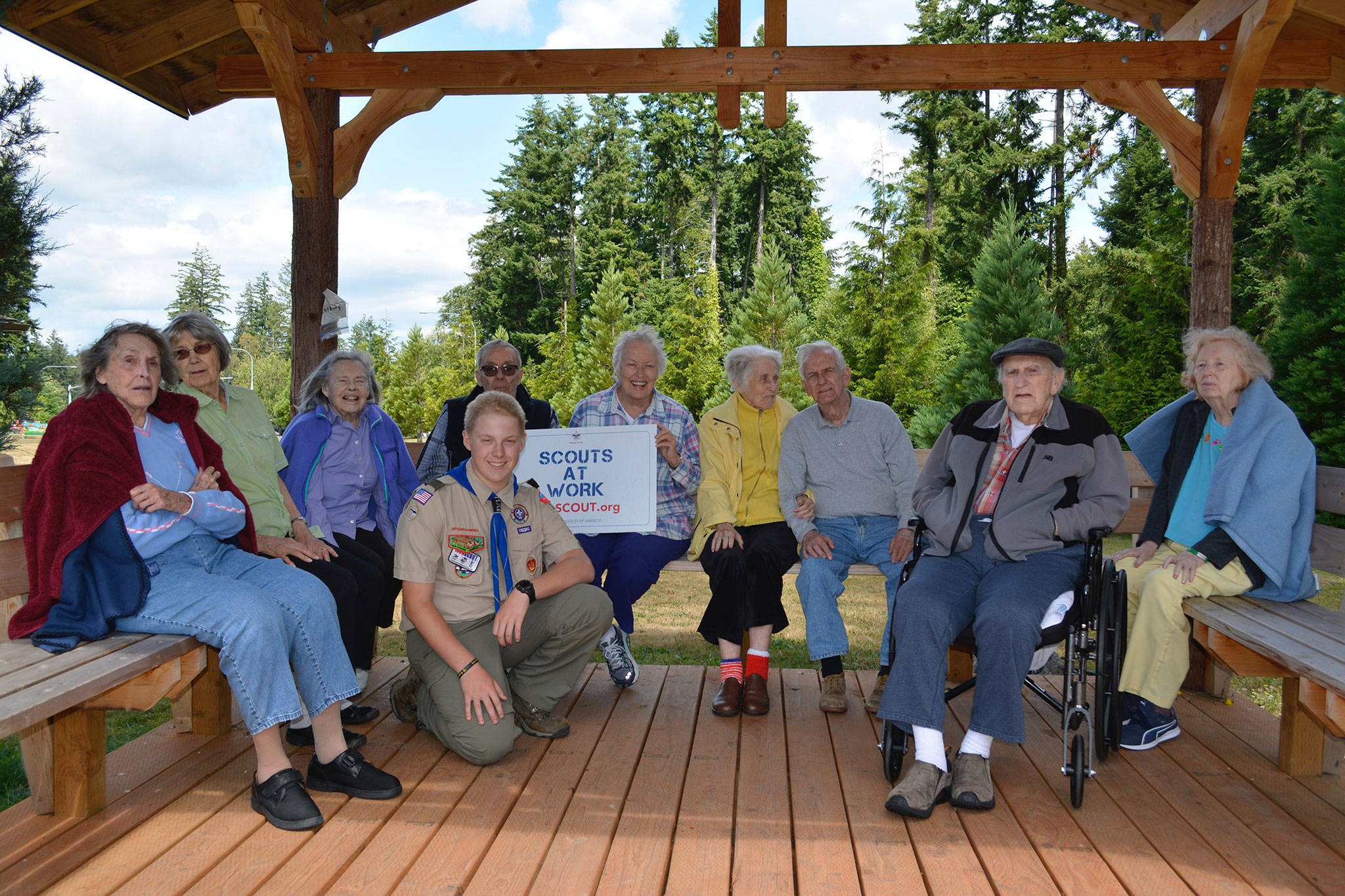 Cruz Strom and residents at the Madrona House on Bainbridge Island enjoy the new gazebo built by Strom and his volunteers. (Mark Krulish/Kitsap News Group)