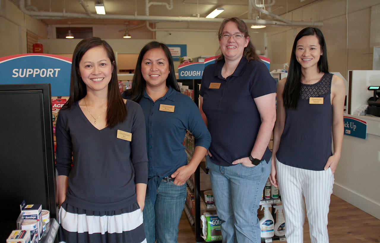 Luciano Marano | Bainbridge Island Review - KC Tan (at left), owner of Bainbridge Island Community Pharmacy, stands with her staff on the new Winslow shop’s opening day.