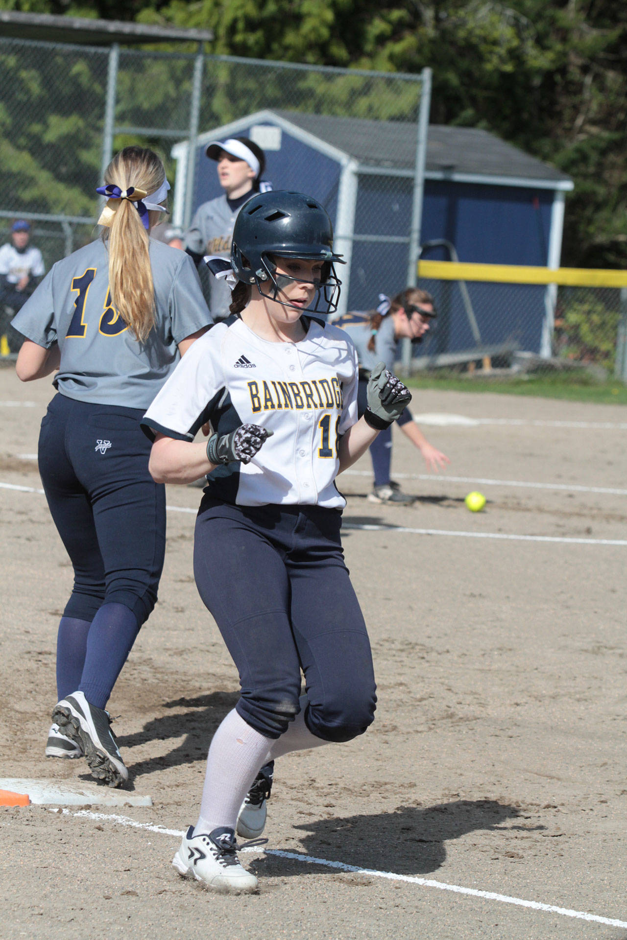 Kensey Baker makes it safely to first as the Wildcats bobble her bunt near the pitcher’s circle. (Brian Kelly | Bainbridge Island Review)