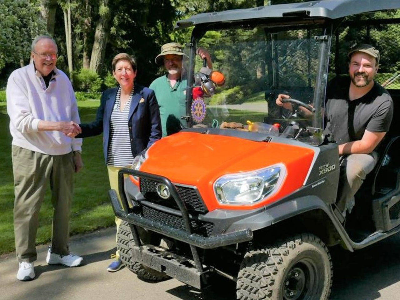 Sue Anderson, Bloedel Reserve’s director of philanthropy, along with driver Emery Tallon and Don McKinney, members of the Bloedel facilities staff, show Mike Lewars the utility truck that was purchased with the 2018 Community Challenge Grant that Bloedel received. (Photo courtesy of the Rotary Club of Bainbridge Island)