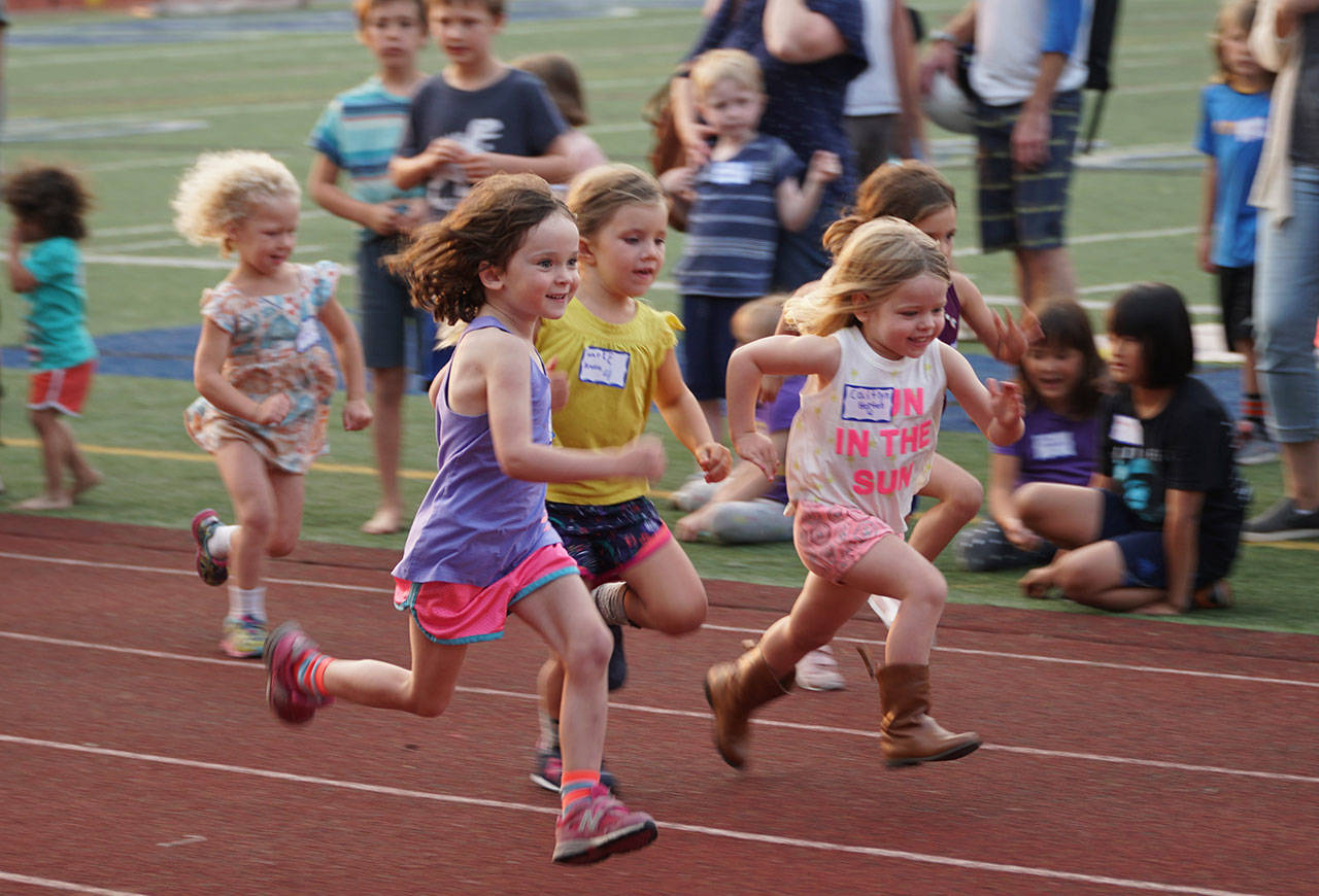 Luciano Marano | Bainbridge Island Review - Young sprinters dash toward the finish line during the 60-meter event at the final Kiwanis All-Comers Track Meet of the year Monday, Aug. 13 at Bainbridge High School.