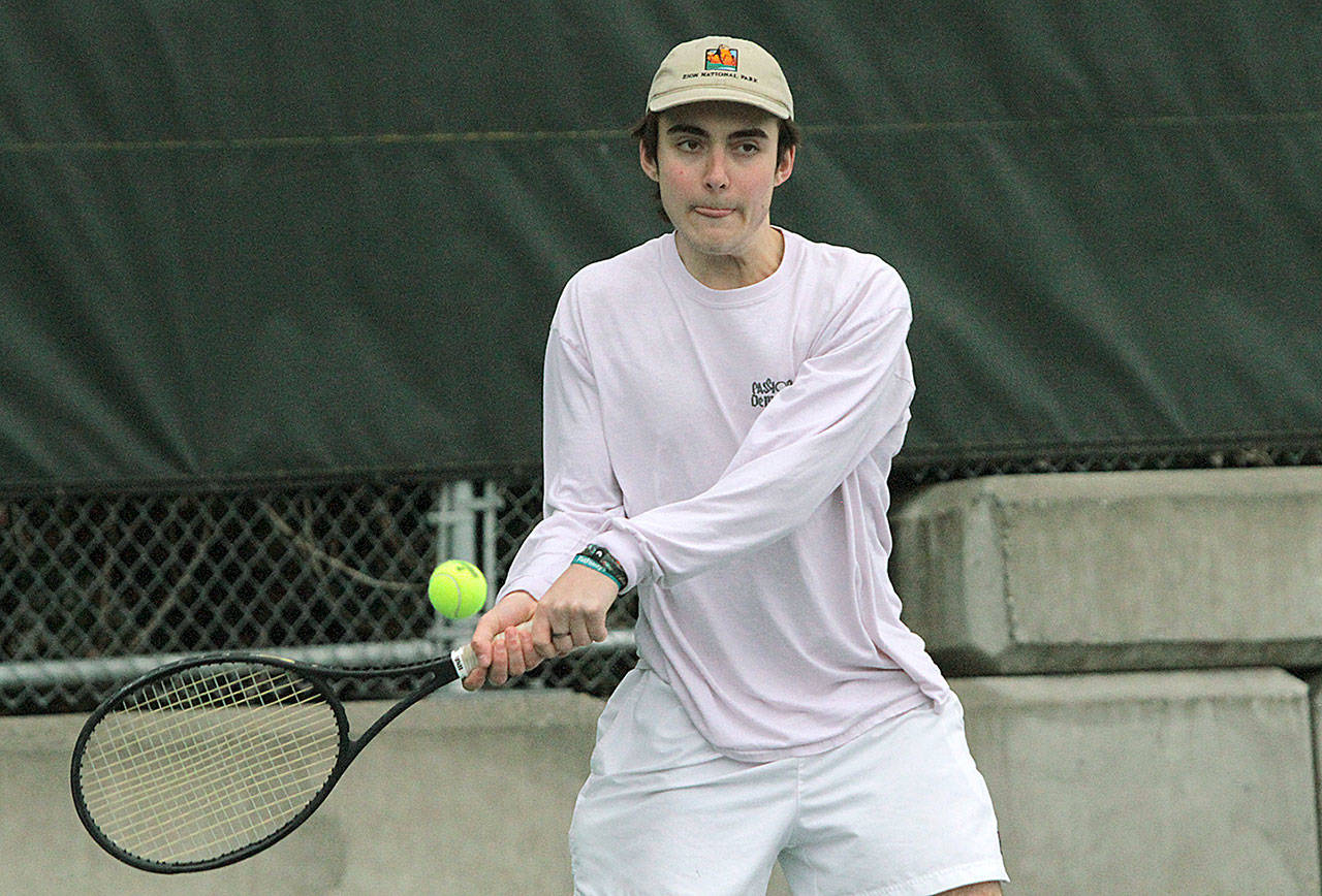 Asher Van Slyke returns the ball Monday in home action against Ingraham. (Brian Kelly | Bainbridge Island Review)