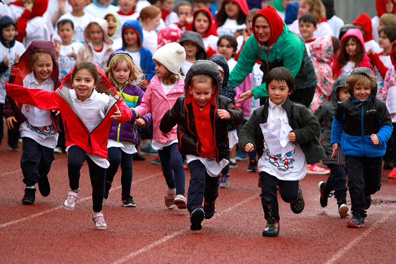 A drippy dash: St. Cecilia jog-a-thon returns to Bainbridge High School track | Photo gallery