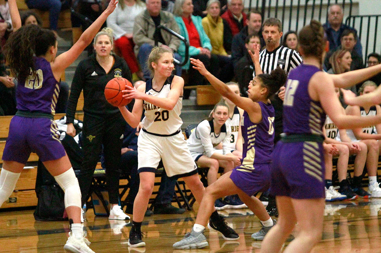 Luciano Marano | Bainbridge Island Review - Spartan sophomore Grace Colburn looks to pass the ball in action against the Viking at Paski Gymnasium.